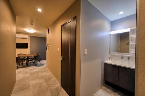 a hallway with a bathroom with a sink and a table at SEVEN House in Fujikawaguchiko