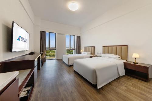 Postel nebo postele na pokoji v ubytování 北京明珠酒店Beijing CSN Pearl Hotel