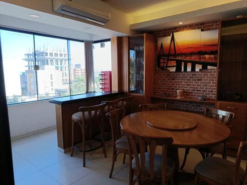 a restaurant with tables and chairs and a large window at Villa Anto in Encarnación