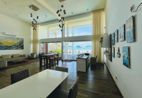 a living room with a table and a dining room at Hikka House - Thema Collection in Hikkaduwa