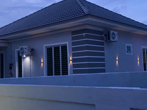 a house with speakers on the side of it at WanZa House in Bachok