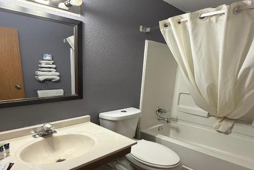 a bathroom with a sink and a toilet and a shower at Coratel Inn and Suites by Jasper Stillwater in Stillwater