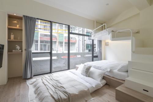 Postel nebo postele na pokoji v ubytování 那間小宅