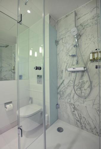 a bathroom with a shower and a sink at AMERON Bonn Hotel Königshof in Bonn