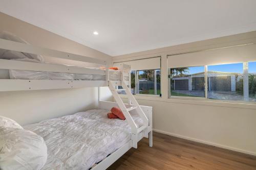 a bedroom with a bunk bed and a ladder at Casa Esperanza by Experience Jervis Bay in Vincentia
