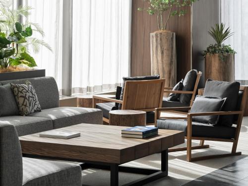 a living room with couches and chairs and a coffee table at Hotel Hankyu GRAN RESPIRE OSAKA in Osaka