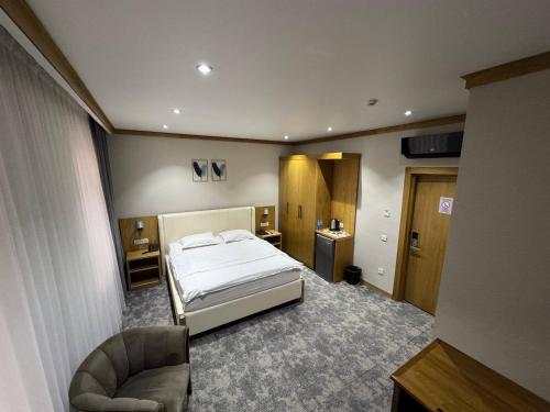 a bedroom with a bed and a chair in it at Muhammad in Andizhan