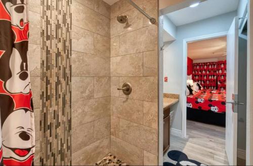 a bathroom with a shower with a walk in shower at Mickey's Hideaway Condo Near Disney in Orlando