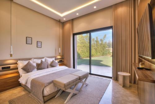 a bedroom with a bed and a large window at Villa Marrakech in Marrakesh