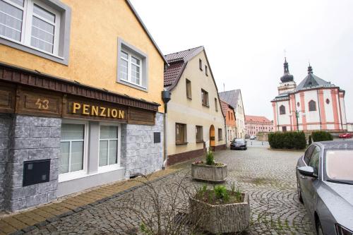 a cobblestone street in a town with buildings at Penzion 43 in Bor