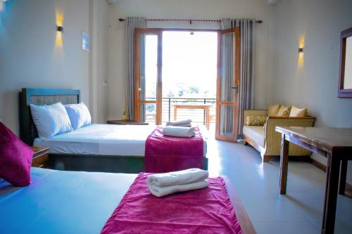 Postel nebo postele na pokoji v ubytování Hotel Grand Utopia