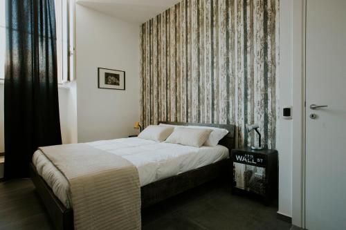 een slaapkamer met een bed en een raam met een gordijn bij Loft 291 in Matera