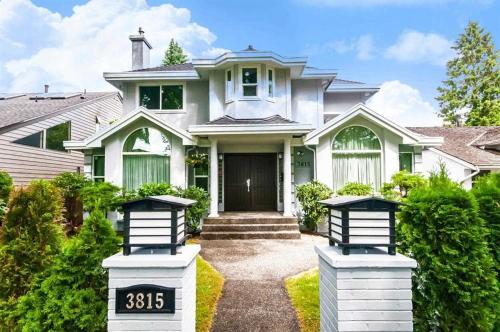 a white house with two address signs in front of it at W 20 House in Vancouver