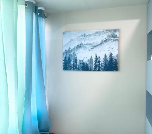 a painting of a winter forest on a wall at Urban Oasis in Cagayan de Oro City in Cagayan de Oro