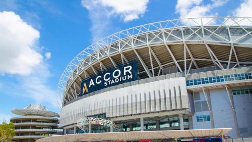 a soccer stadium with a sign on top of it at New Apartment in Olympic Park with Pool and Gym in Sydney