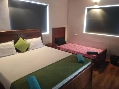 a room with two beds and a chair in it at Solace Transit Villa in Katunayake