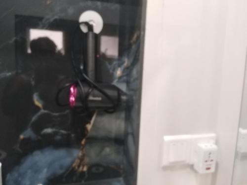 a staircase in a room with a light on the wall at Solace Transit Villa in Katunayake