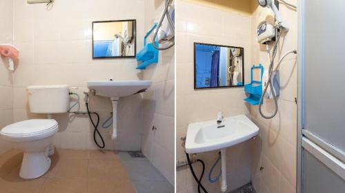 Kampong Salengにあるhotel hen henの白いトイレと洗面台のあるバスルーム