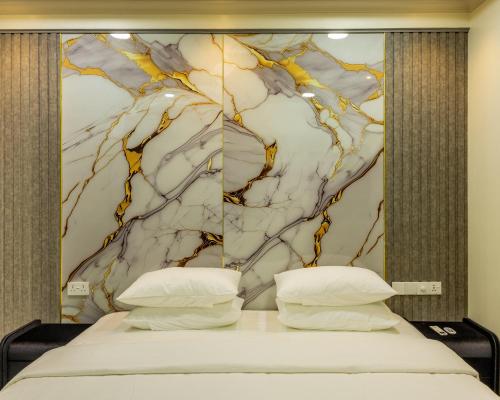 a bedroom with a bed with a marble headboard at Villaasa in Shaviyani Atoll