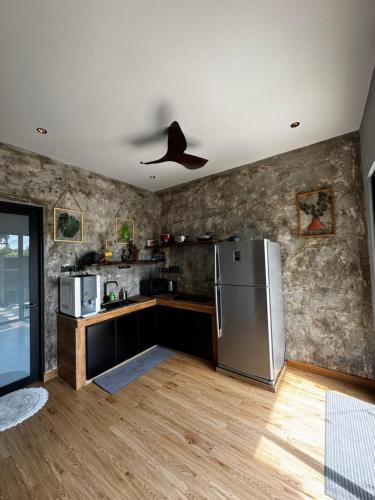 a kitchen with a refrigerator and a ceiling fan at LA Villas Kuantan Private Pool,Near Beach,BBQ,Karaoke in Kuantan