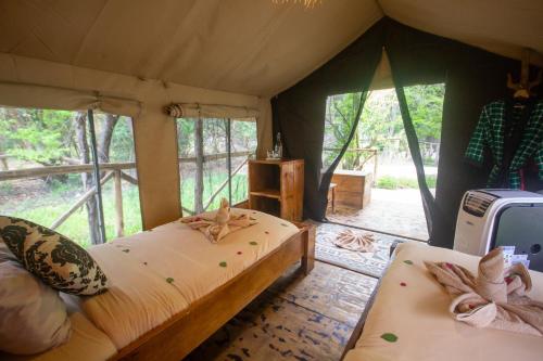 a bedroom with a bed in a tent at Africa Safari Selous Camping in Kwangwazi