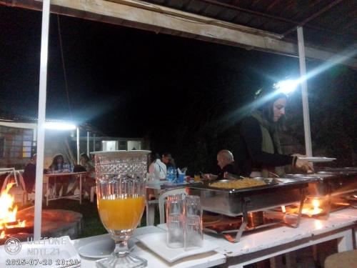 a bar with a table with a glass of beer at Homebase gardens homestay in Nakuru