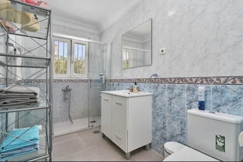 a bathroom with a toilet and a sink and a shower at Villa with Private Pool and Gorgeous View in Caleta De Velez