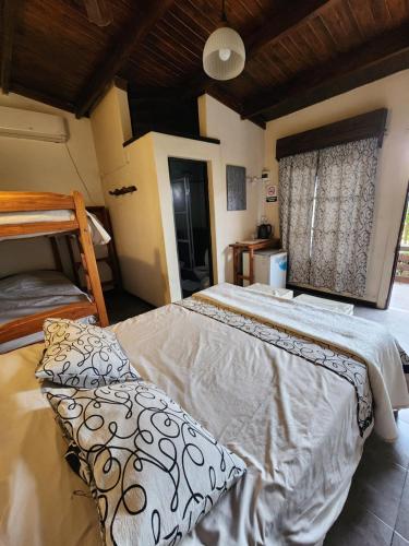 a bedroom with a large bed and a window at Esquina Apart in Esquina