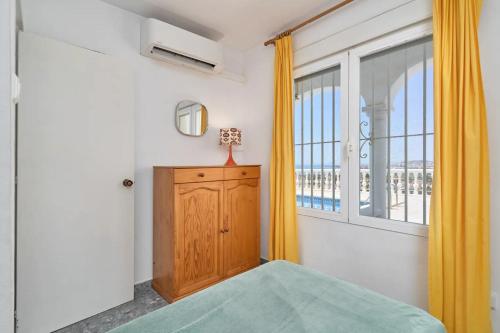 a bedroom with a bed and a window at Villa with Private Pool and Gorgeous View in Caleta De Velez