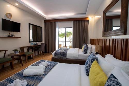 Postel nebo postele na pokoji v ubytování Alima ARQ Beach Resort