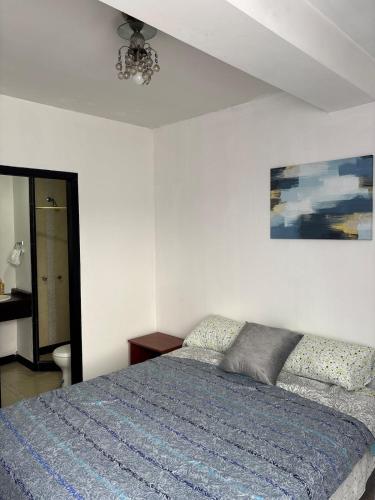 a bedroom with a bed and a ceiling fan at Comfortable apartment in South Quito in Quito