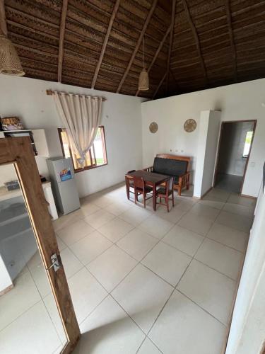a living room with a table and a couch at Kategha Beach Guesthouse in Praia do Tofo