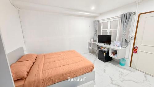 バンバンセーンにあるสินอนันต์ อพาร์ทเม้นต์Sinanan apartmentの白いベッドルーム(ベッド1台、テレビ付)