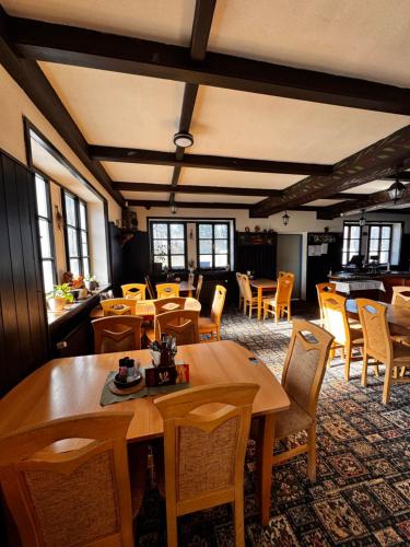 a dining room with wooden tables and chairs at Penzion Landštejnský dvůr in Slavonice