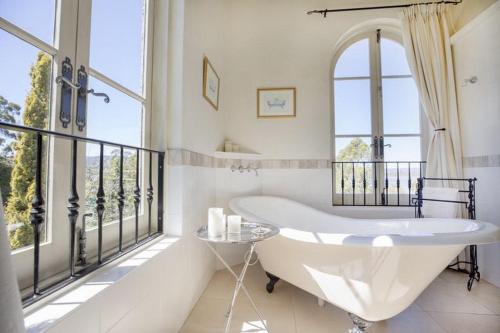 a bath tub in a bathroom with a balcony at Villa Howden in Margate