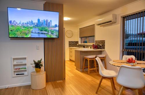 a kitchen with a flat screen tv on a wall at Sorell Gateway Villa in Sorell