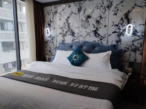 Ένα ή περισσότερα κρεβάτια σε δωμάτιο στο Chongqing Justom Family Serviced Apartments 3