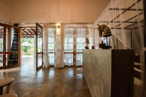 a living room with a counter and a window at TROPICAL HOUSE - Jungleside Villa in Hikkaduwa