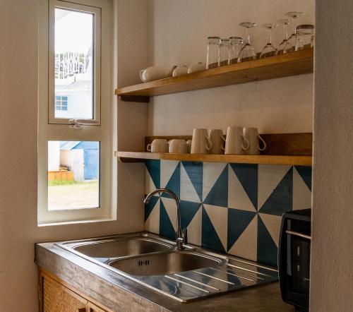 a kitchen with a sink and a window at Bigarade sur Mer 