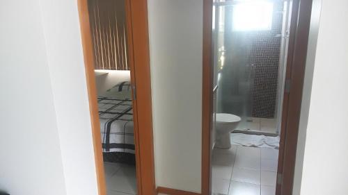 a bathroom with a bed and a toilet in a room at Apartamento Manaus Arena da Amazonia in Manaus
