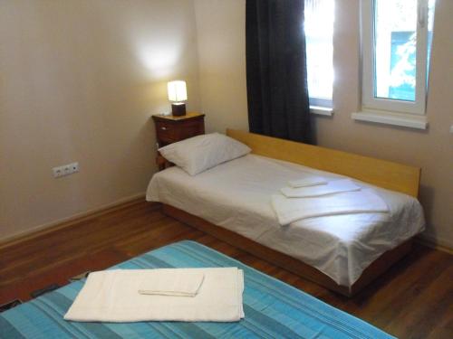 a bedroom with a bed with two towels on it at Julia Garden in Burgas City
