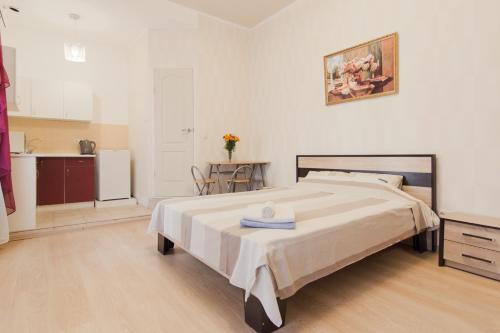 a bedroom with a large bed and a kitchen at Best Apartment in the city centre in Odesa