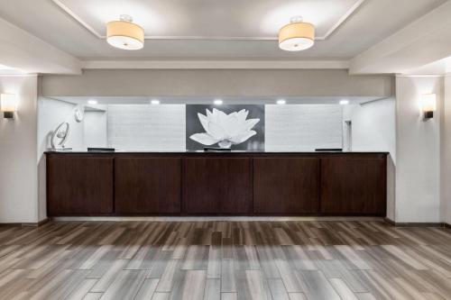 a waiting room with a lotus sign on the wall at La Quinta by Wyndham San Antonio Airport in San Antonio