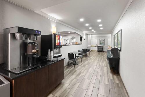 a room with a bar with aasteryasteryasteryasteryasteryasteryasteryasteryastery at La Quinta by Wyndham San Antonio Airport in San Antonio