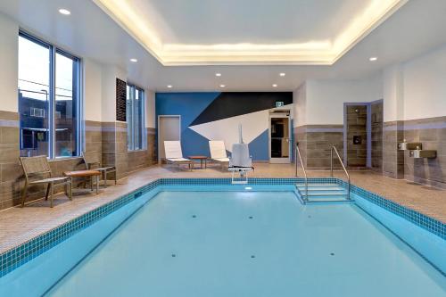 a large swimming pool in a hotel room with a swimming pool at Hyatt Place Prince George in Prince George