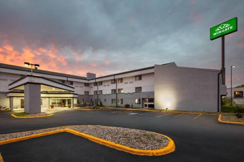 an empty parking lot in front of a hospital at Wingate by Wyndham Lincoln Airport East I-80 in Lincoln