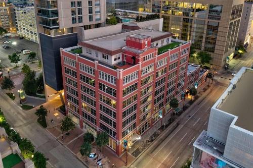 an overhead view of a red building in a city at The District at Hogg Palace, A Wyndham Hotel in Houston