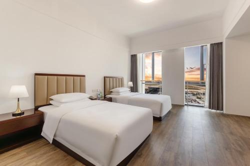 Postel nebo postele na pokoji v ubytování 北京明珠酒店Beijing CSN Pearl Hotel