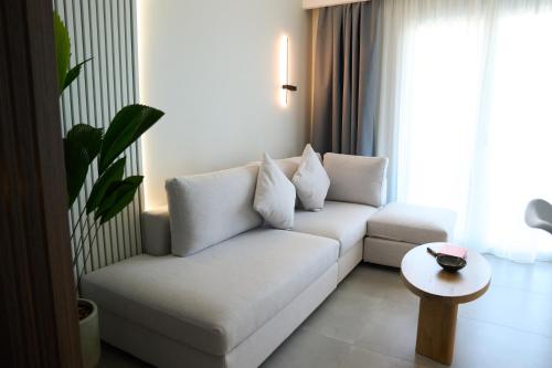 a living room with a white couch and a table at Nexa Suite in Komotini