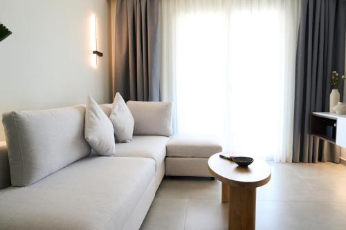 a living room with a white couch and a table at Nexa Suite in Komotini